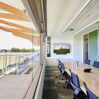 A photo of a boardroom overlooking a football pitch at the Sam Kerr Football Centre in Queens Park, Perth