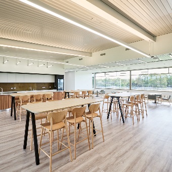 A photo of tables and chairs near a kitchen area at the Sam Kerr Football Centre in Queens Park, Perth