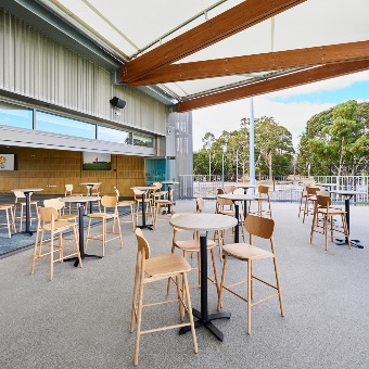 A photo of tables and chairs set up on a balcony area at the Sam Kerr Football Centre in Queens Park, Perth