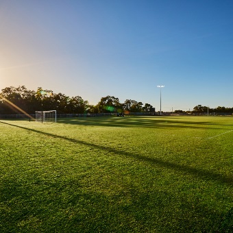 A photo of one of the grassed full sized playing pitches at the Sam Kerr Football Centre in Queens Park, Perth