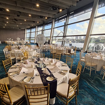 Photo of circular tables set up in a function room at Optus Stadium in Burswood, Perth