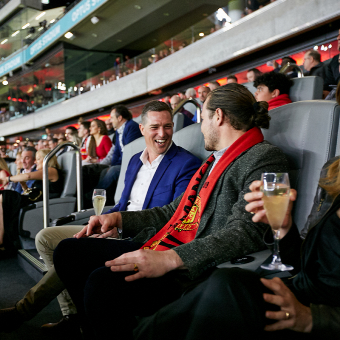A close up shot of people sitting in premium seating at Optus Stadium