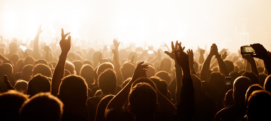 A photo of the back of people standing in the crowd during a performance at RAC Arena in Perth